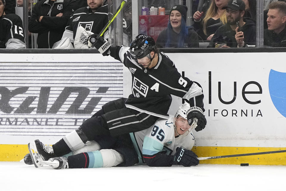 Los Angeles Kings right wing Adrian Kempe, top, falls over Seattle Kraken left wing Andre Burakovsky during the second period of an NHL hockey game Wednesday, April 3, 2024, in Los Angeles. (AP Photo/Mark J. Terrill)