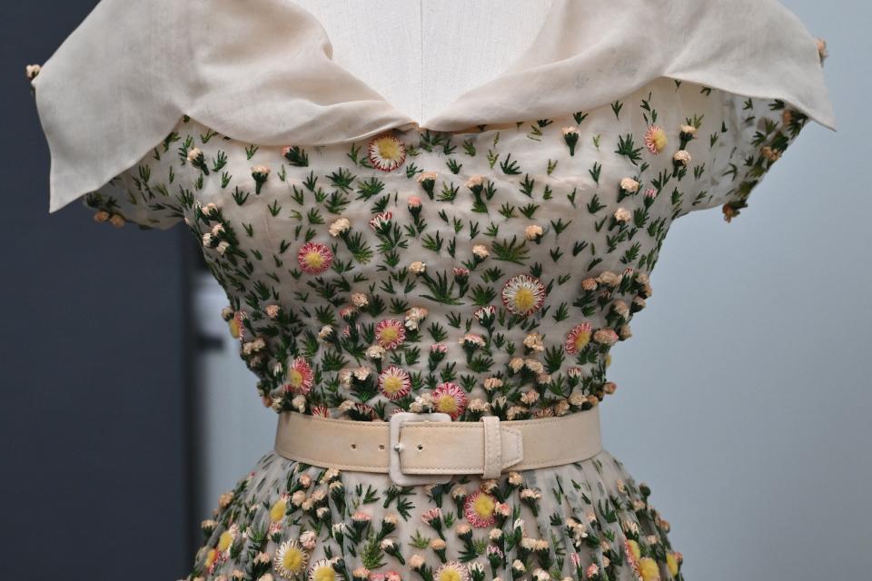 Midsection of a printed dress with a belted waist, showing detail of the garment's design and texture