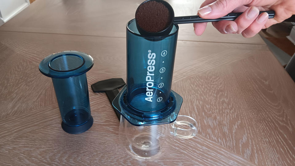 Adding coffee grinds into chamber on AeroPress