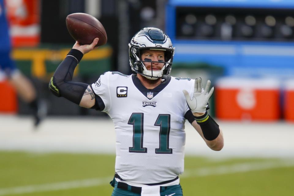 FILE - Then-Philadelphia Eagles quarterback Carson Wentz warms up before an NFL football game against the Green Bay Packers in Green Bay, Wisc., in this Sunday, Dec. 6, 2020, file photo. The Colts think Wentz can re-emerge as a franchise quarterback. (AP Photo/Matt Ludtke, File)