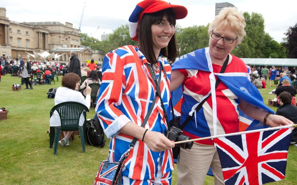 Picnic goers wearing Union Jacks as they enjoy a special picnic in the grounds of Buckingham Palace, ahead of the Diamond Jubilee in 2012 - Getty Images