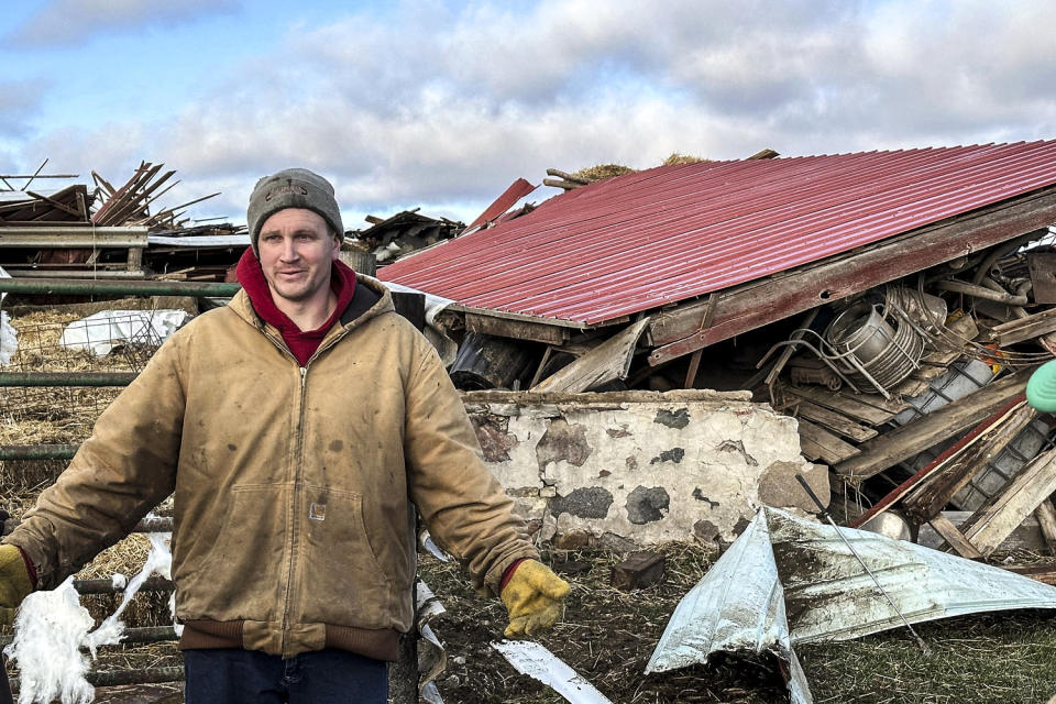 Image: Matt Artis, 34, surveys the wreckage on Feb. 9, 2024, after a tornado struck his farm in the Town of Porter, Wis.,  (Todd Richmond / AP)