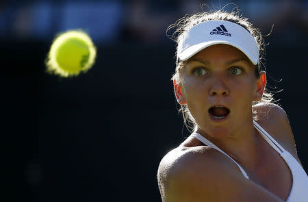 Simona Halep of Romania hits the ball during her match against Jana Cepelova of Slovakia at the Wimbledon Tennis Championships in London, June 30, 2015. REUTERS/Stefan Wermuth