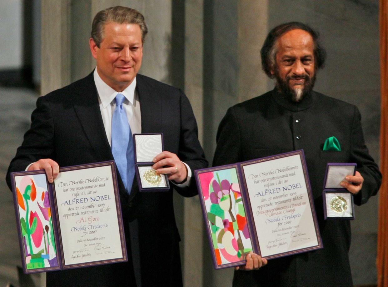 Nobel Peace Prize winners Al Gore, left, and Rajendra Pachauri, the chief scientist for the United Nations Intergovernmental Panel on Climate Change, hold their medals and diplomas at the Nobel Peace Prize ceremony at City Hall in Oslo, Norway, on Dec. 10, 2007.