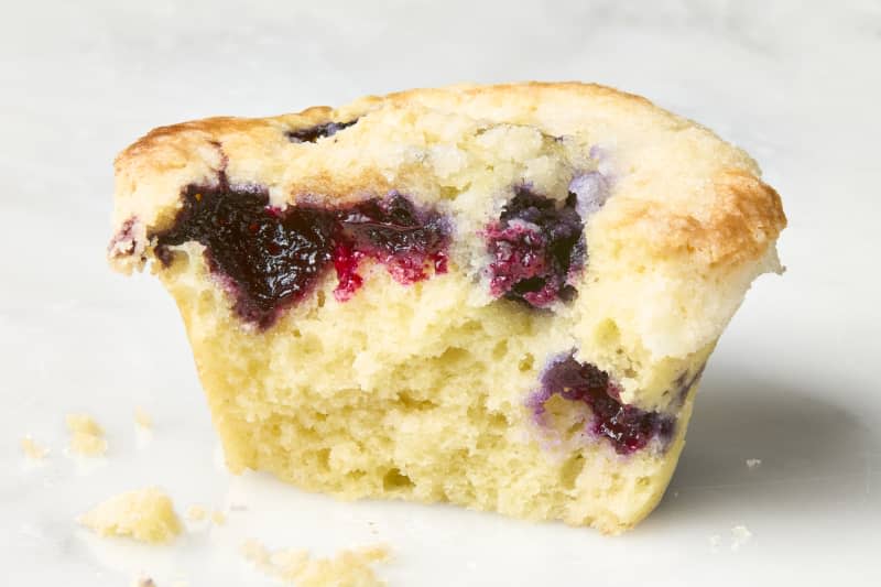 head on shot of the Joanna Gaines blueberry muffin with a bite taken out of it.