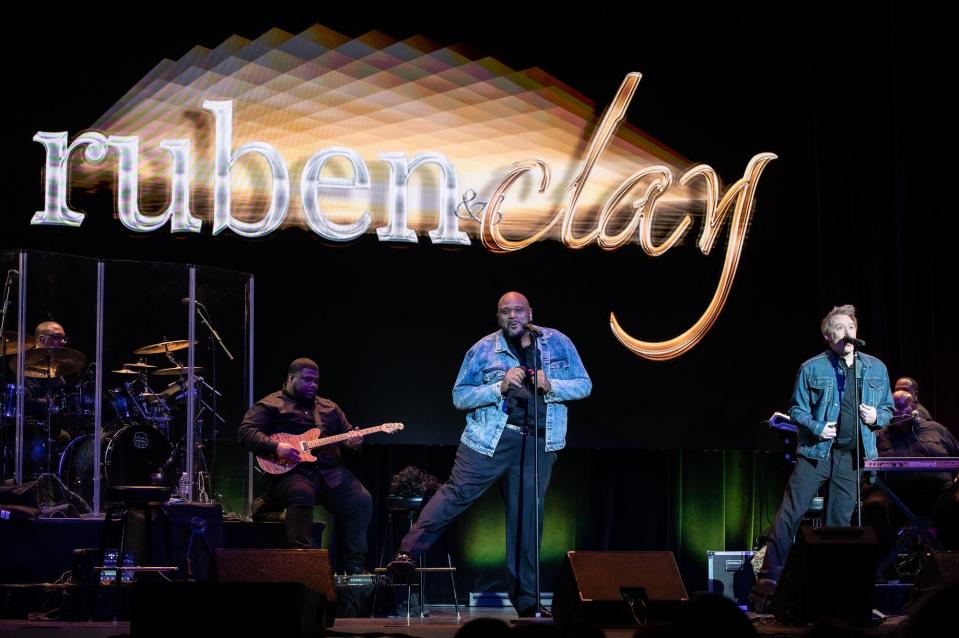 Ruben Studdard (left) and Clay Aiken dance while performing "You Got It (The Right Stuff)" on May 2, 2023 at the Midland Theatre.
