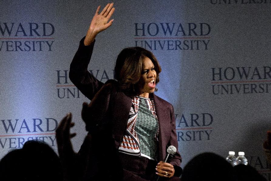 First lady Michelle Obama cheers as she arrives for a town hall meeting at Howard University in Washington, Thursday April 17, 2014. The first lady joined juniors and seniors from Chicago public high schools on the first day of their four-day visit to Howard University, as part of a program to immerse talented high school students in a college campus environment. (AP Photo/Jacquelyn Martin)