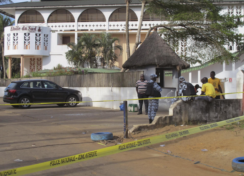 FILE - A road leading to the Etoile du Sud Hotel, seen in the background, is cordoned off near the site of an attack in Grand-Bassam, Ivory Coast, on March 15, 2016. Eleven people have been sentenced to life in prison in Ivory Coast on Wednesday Dec. 28, 2022 after being convicted of carrying out an Islamic extremist attack that killed 19 people and injured dozens more on a tourist beach nearly seven years ago. (AP Photo/Carley Petesch, File)