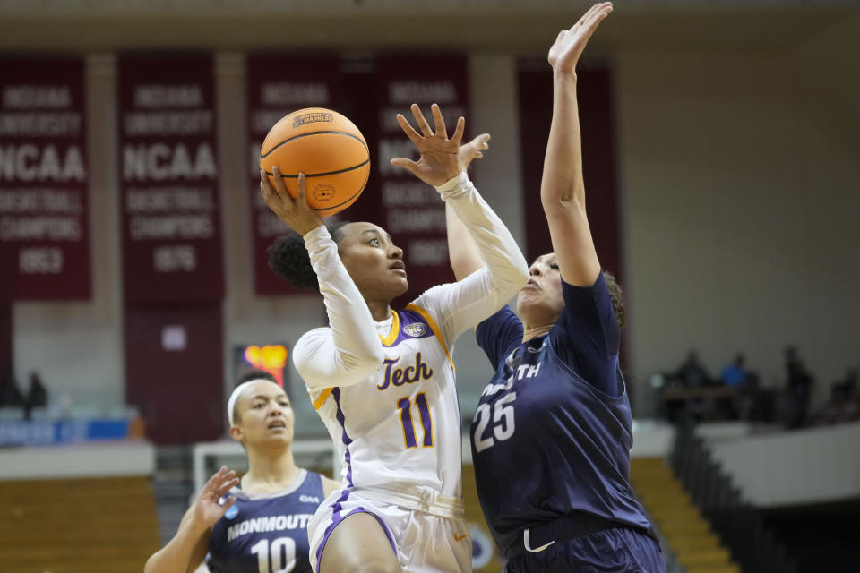 Tennessee Tech guard Maaliya Owens (11) shoots against Monmouth forward Lucy Thomas (25) during the second half of a First Four college basketball game in the NCAA women's basketball tournament in Bloomington, Ind., Thursday, March 16, 2023. Tennessee Tech won 79-69. (AP Photo/AJ Mast)