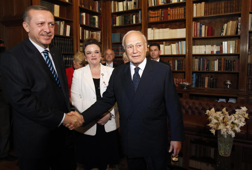 FILE - Greek President Karolos Papoulias, right, shakes hands with with Turkish Prime Minister Tayyip Erdogan during their meeting in Athens, Friday, May 14, 2010. Papoulias, a former President of Greece, has died at the age of 92, Greece's state news agency ANA reported on Sunday, Dec. 26, 2021. Papoulias, a lawyer by training, was close to socialist leader Andreas Papandreou and served in all his governments from 1981-1996, all in foreign affairs positions, ending as Foreign Minister. (John Kolesidis, Pool Photo via AP, File)