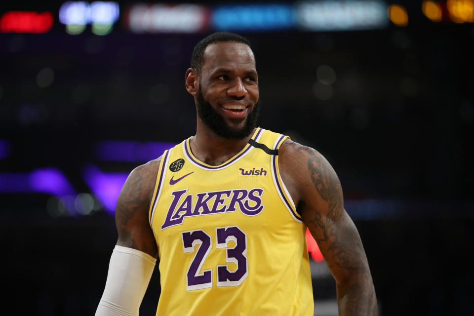 LeBron James smiles on the court in a game against the Philadelphia 76ers.