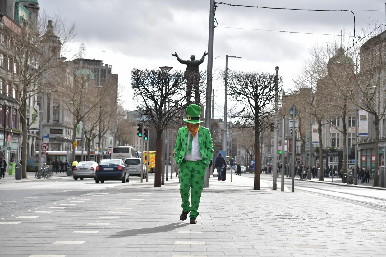 A lone reveler marks St. Patrick's Day by walking down Dublin's parade route after the annual event was canceled due to coronavirus concerns. (Photo: Charles McQuillan/Getty Images)