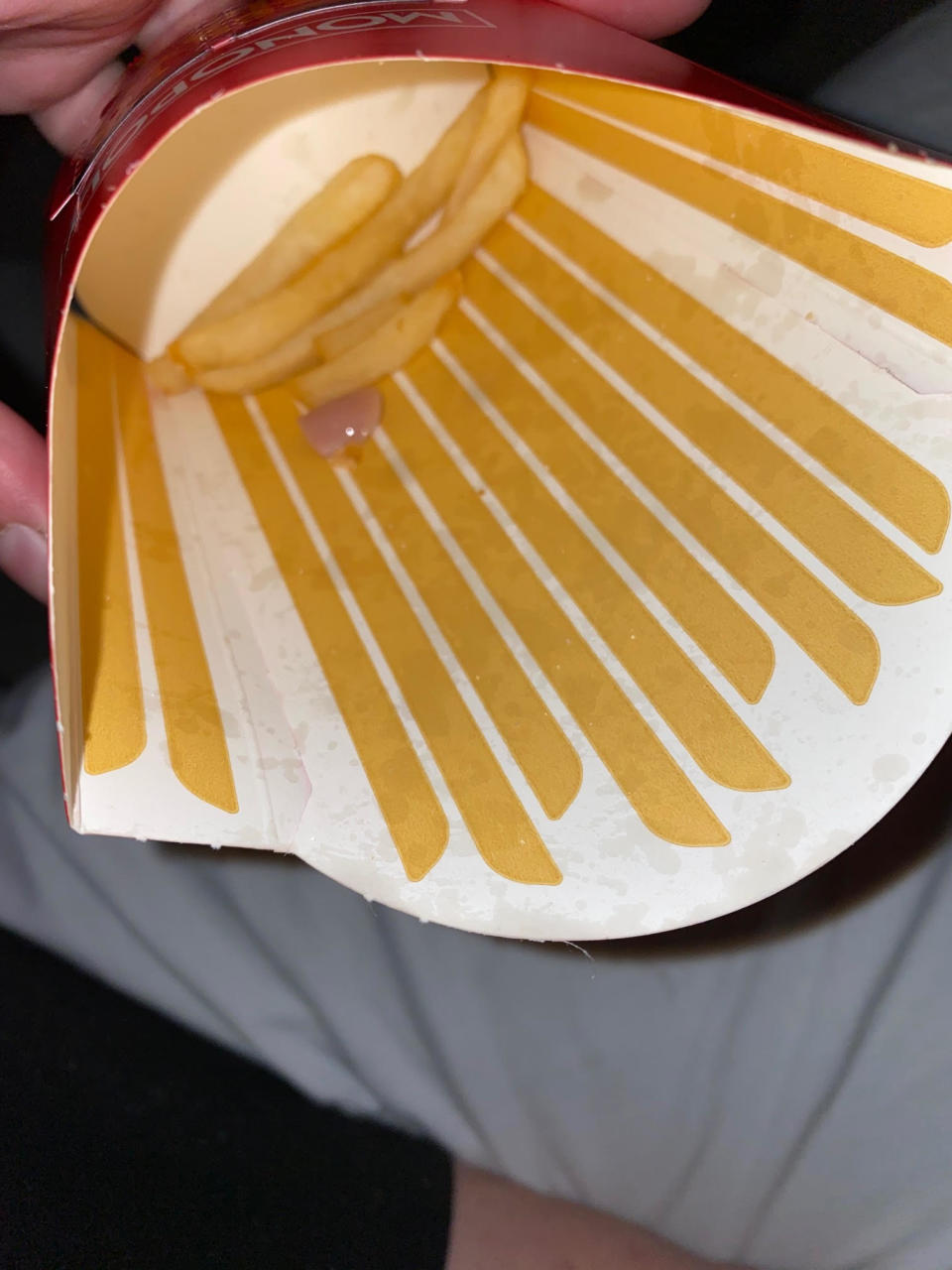 False nail with purple polish in McDonald's fries packet. Source: Supplied