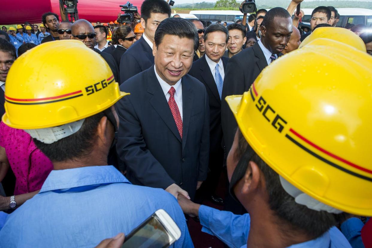 Xi Jinping shakes hands with Chinese construction workers at a Belt and Road Initiative site in Trinidad and Tobago in June 2023. <a href="https://www.gettyimages.com/detail/news-photo/chinas-president-xi-jinping-shake-hands-with-chinese-news-photo/169793922" rel="nofollow noopener" target="_blank" data-ylk="slk:Frederic Dubray/AFP via Getty Images;elm:context_link;itc:0;sec:content-canvas" class="link ">Frederic Dubray/AFP via Getty Images</a>