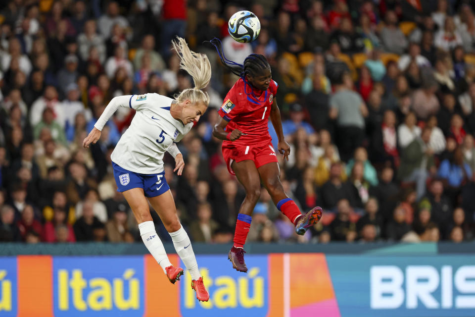 England's Alex Greenwood, left, battles for the ball with Haiti's Louis Batcheba during the Women's World Cup Group D soccer match between England and Haiti in Brisbane, Australia, Saturday, July 22, 2023. (AP Photo/Tertius Pickard)