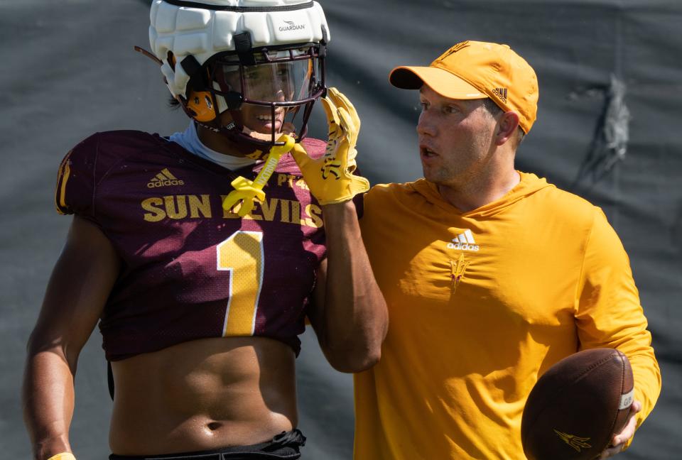 Head coach Kenny Dillingham (right) talks with WR Xavier Guillory during practice on Aug. 3, 2023, at ASU's Kajikawa Practice Field in Tempe.