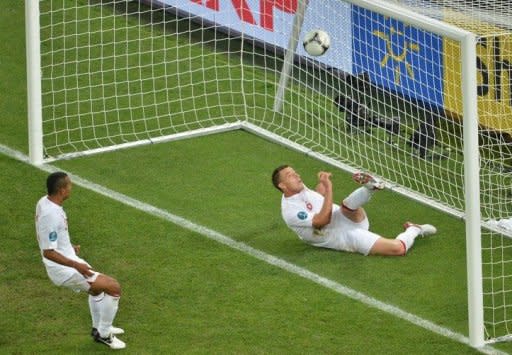 English defender John Terry (R) clears the ball during the Euro 2012 football championships match England vs Ukraine at the Donbass Arena in Donetsk. England scraped into the quarter-finals of Euro 2012 here Tuesday after a goal-line refereeing blunder helped them to a 1-0 win over Ukraine which sent the co-hosts crashing out