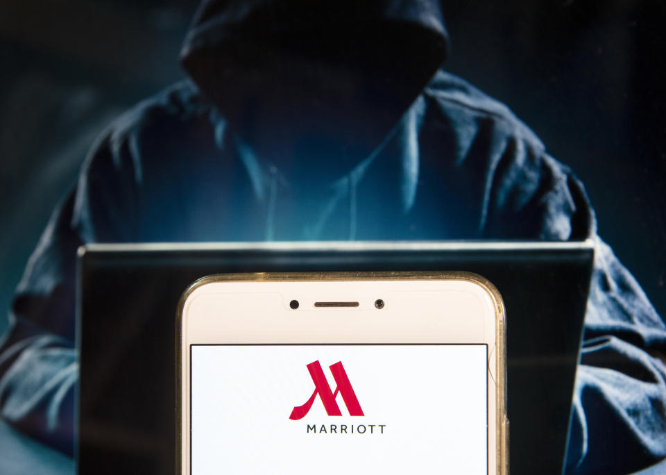 HONG KONG - 2018/12/02:  In this photo illustration, the American multinational diversified hospitality company Marriott International logo is seen displayed on an Android mobile device with a figure of hacker in the background. (Photo Illustration by Miguel Candela/SOPA Images/LightRocket via Getty Images)