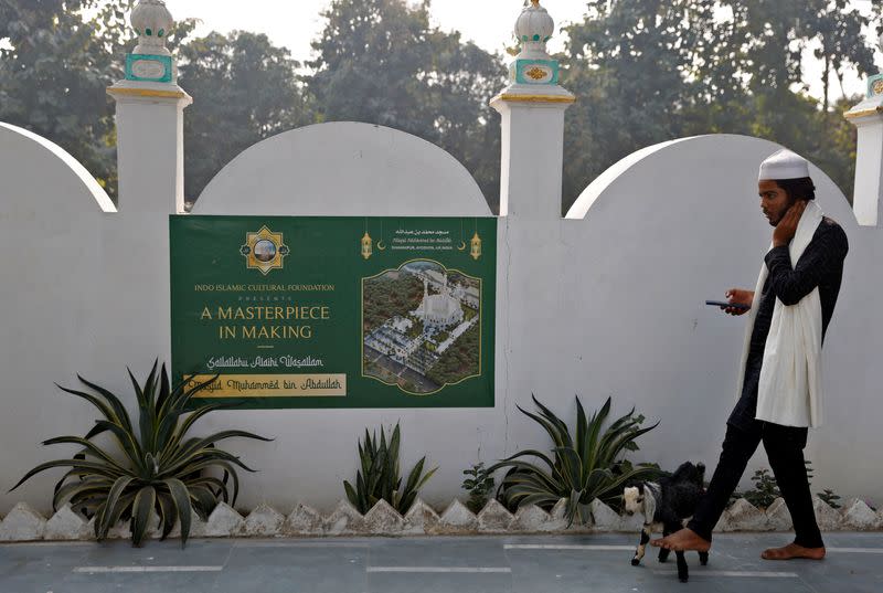 FILE PHOTO: A Muslim man walks his goat at a site that was allotted by the authorities for a new mosque, about 15 miles from the Hindu Ram Temple, in Ayodhya