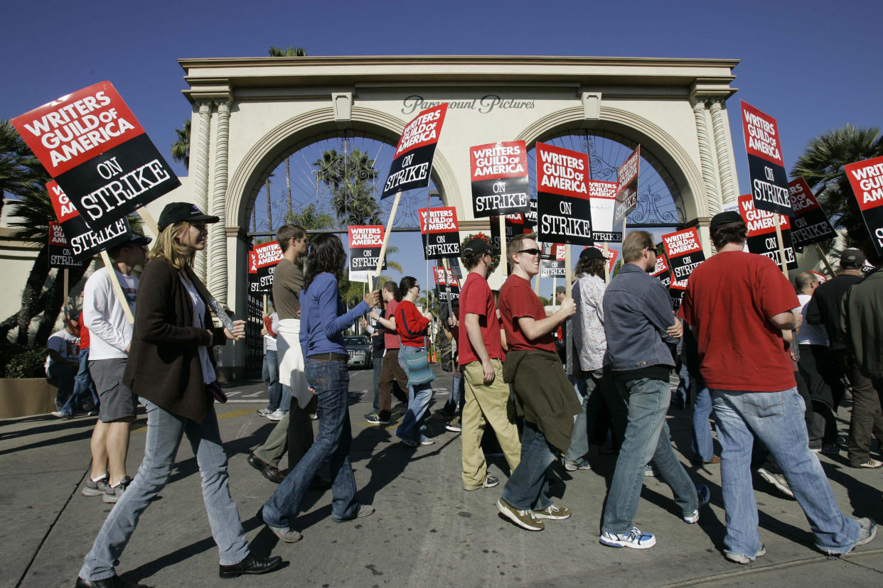 FILE - Striking writers walk the picket line outside Paramount Studios in Los Angeles on Dec. 13, 2007. Television and movie writers on Monday, May 1, 2023, declared that they will launch an industrywide strike for the first time since 2007, as Hollywood girded for a shutdown in a dispute over fair pay in the streaming era. (AP Photo/Nick Ut, File)