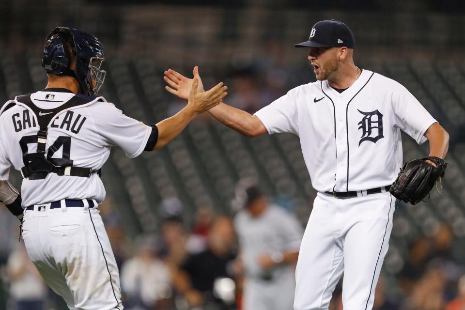 Detroit Tigers relief pitcher Alex Lange (57) celebrates with catcher Dustin Garneau (64) after the game against the Chicago White Sox at Comerica Park on Monday, Sept. 20, 2021.