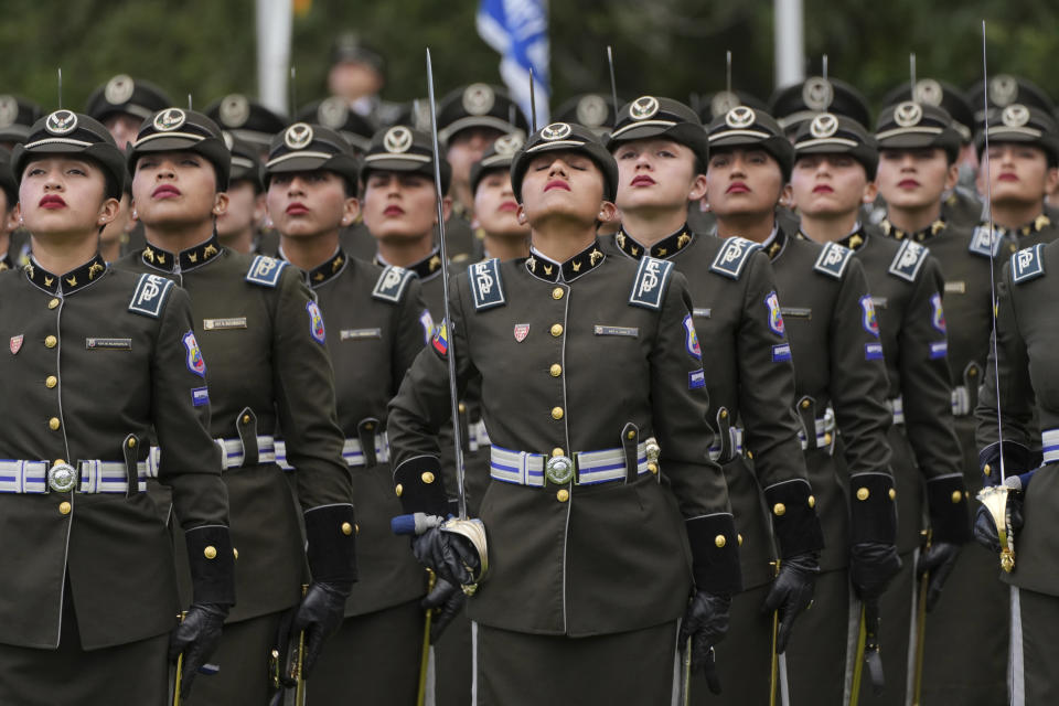 Agentes de la policía guardan un minuto de silencio por las víctimas de la violencia en el país, durante un acto de entrega de nuevos equipos de seguridad, en la escuela policial General Alberto Enríquez Gallo, en Quito, Ecuador, el 22 de enero de 2024. (AP Foto/Dolores Ochoa)