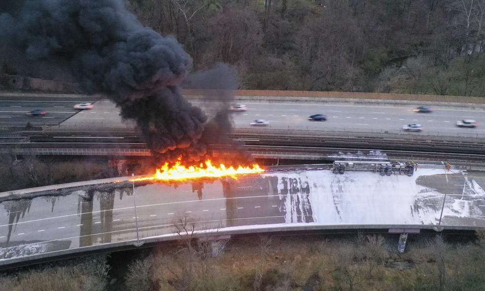 Fuel from an overturned tanker truck burns on northbound Interstate 795 in Pikesville, Md., on Friday morning, March 24, 2023. The driver of the truck was transported to a hospital for treatment, according to state police. (Jerry Jackson/The Baltimore Sun via AP)