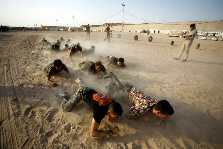 Iraqi Shiite fighters from the Popular Mobilisation units take part in a training session in the holy city of Najaf on August 24, 2015