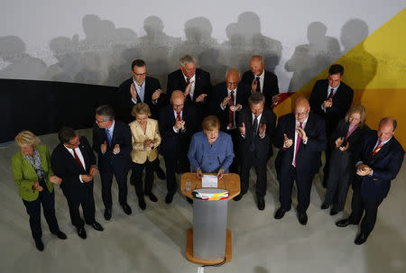 Christian Democratic Union CDU party leader and German Chancellor Angela Merkel reacts on first exit polls in the German general election (Bundestagswahl) in Berlin, Germany, September 24, 2017. REUTERS/Pawel Kopczynski