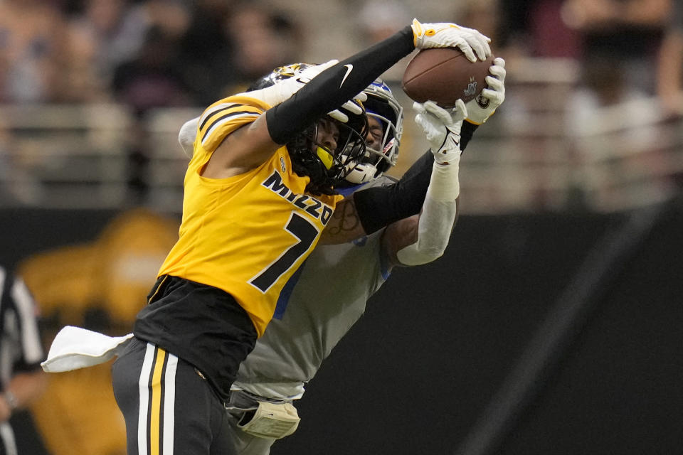 Missouri defensive back Kris Abrams-Draine (7) intercepts a pass intended for Memphis wide receiver Tauskie Dove during the second half of an NCAA college football game Saturday, Sept. 23, 2023, in St. Louis. (AP Photo/Jeff Roberson)