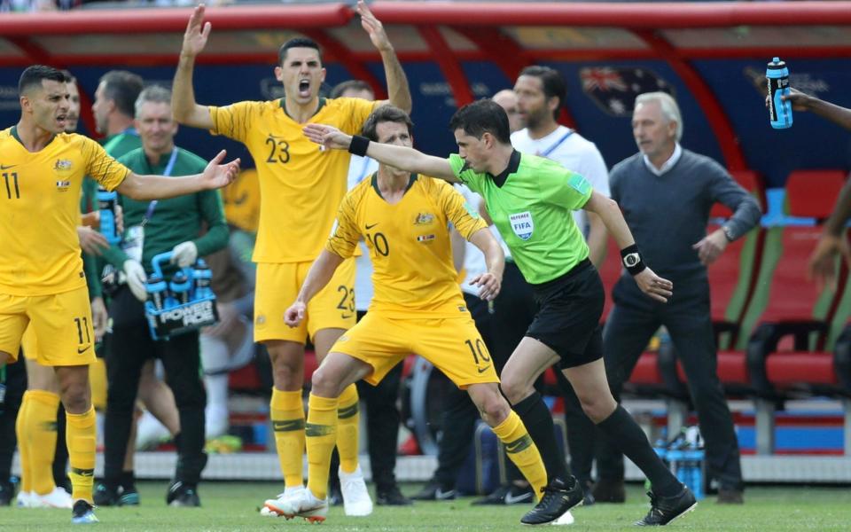 Australia players react furiously to a penalty awarded via VAR in their opening game with France