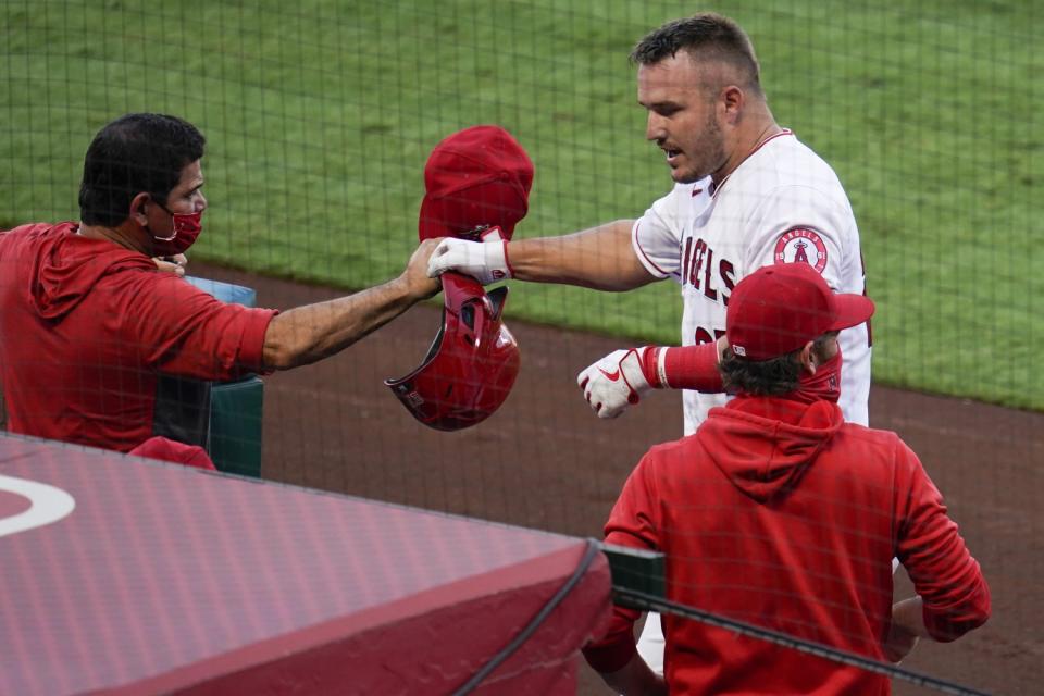 The Angels' Mike Trout celebrates with teammates after hitting a two-run homer Aug. 15, 2020.