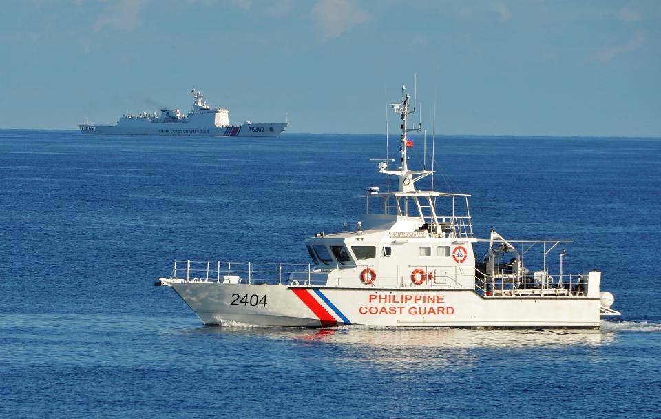 FILE PHOTO: This photo taken on May 14, 2019, a Philippine coast guard ship (R) sails past a Chinese coastguard ship during an joint search and rescue exercise between Philippine and US coastguards near Scarborough shoal, in the South China Sea. (Photo: TED ALJIBE/AFP/Getty Images)