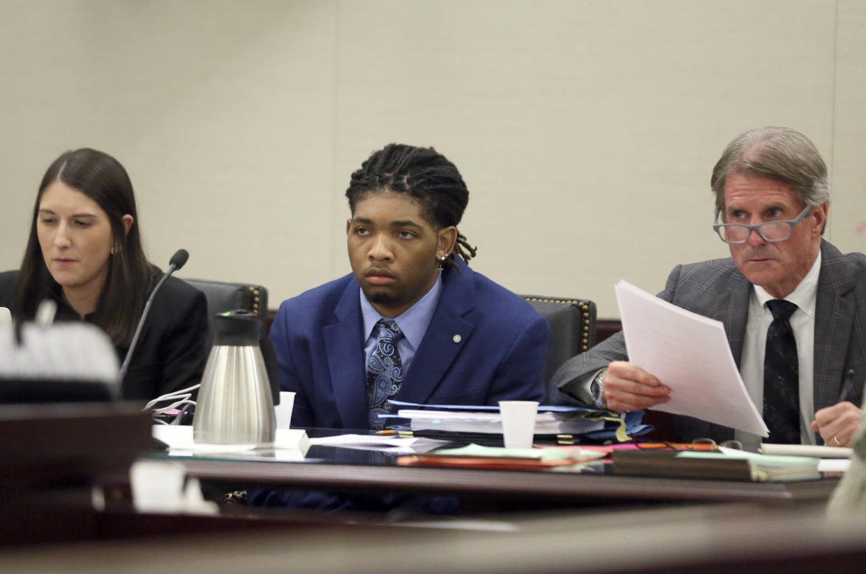 Isimemen David Etute, center, listens with his defense team, attorney Katie Turk, left, and Jimmy Turk, right, in Montgomery County Circuit Court in Christiansburg, Va., Wednesday May 25 2022. (Matt Gentry/The Roanoke Times via AP, Pool)