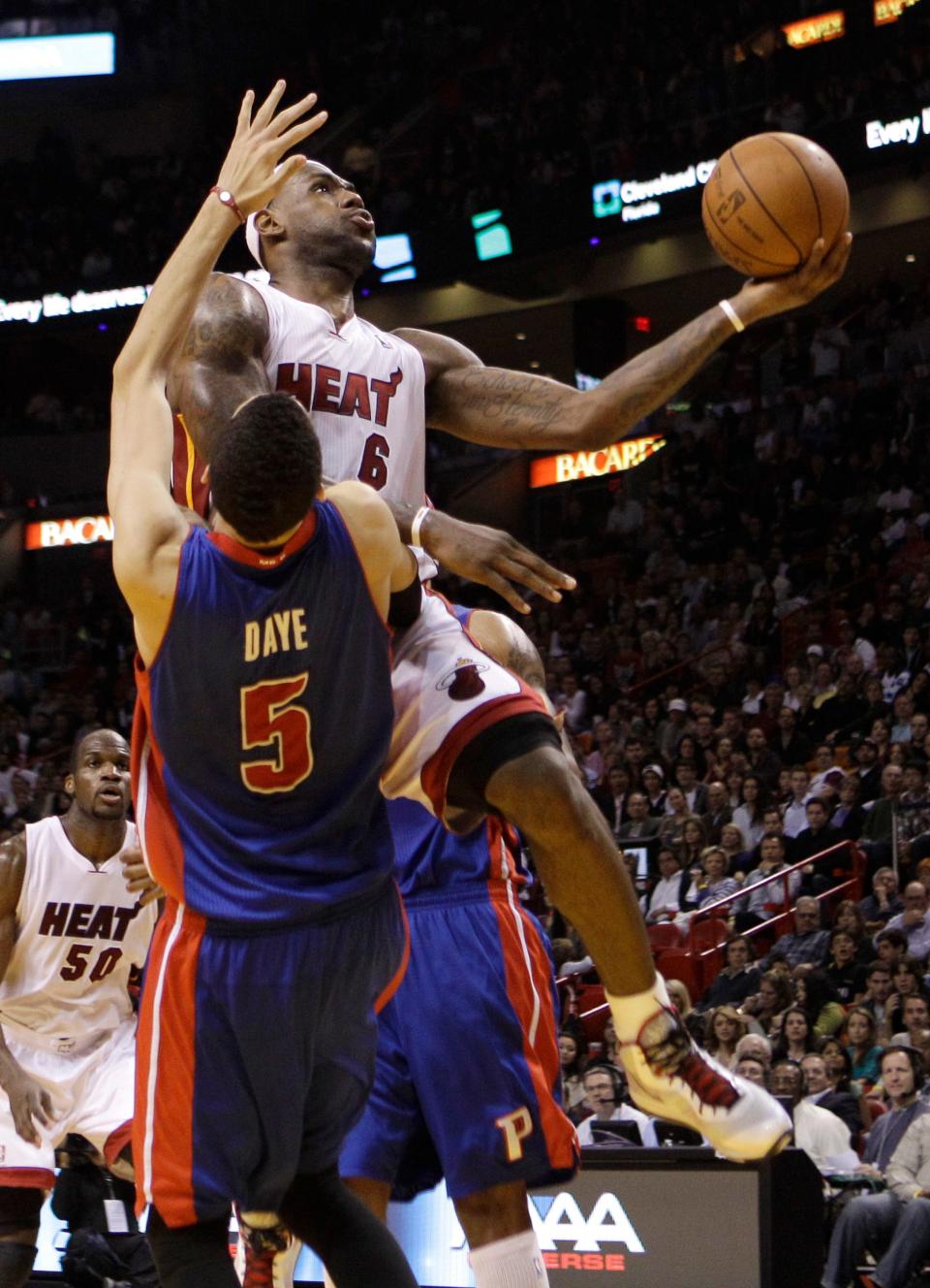 Miami Heat's LeBron James (6) is fouled by Detroit Pistons' Austin Daye (5) while shooting in the fourth quarter during an NBA basketball game in Miami, Friday, Jan. 28, 2011. The Heat defeated the Pistons 88-87.