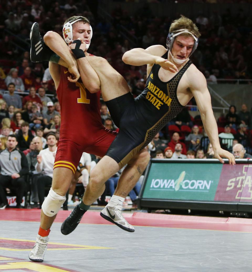 Iowa State's Julien Broderson, left, takes down Arizona State's Josh Nummer during their 174-pound bout at Hilton Coliseum on Sunday.