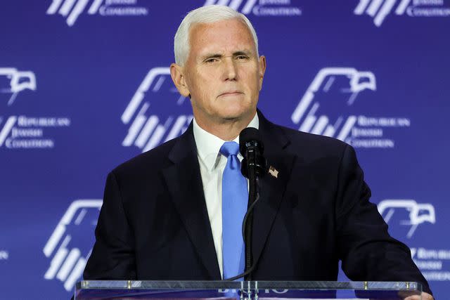 <p>Ethan Miller/Getty</p> Mike Pence speaks after suspending his campaign for president on Oct. 28