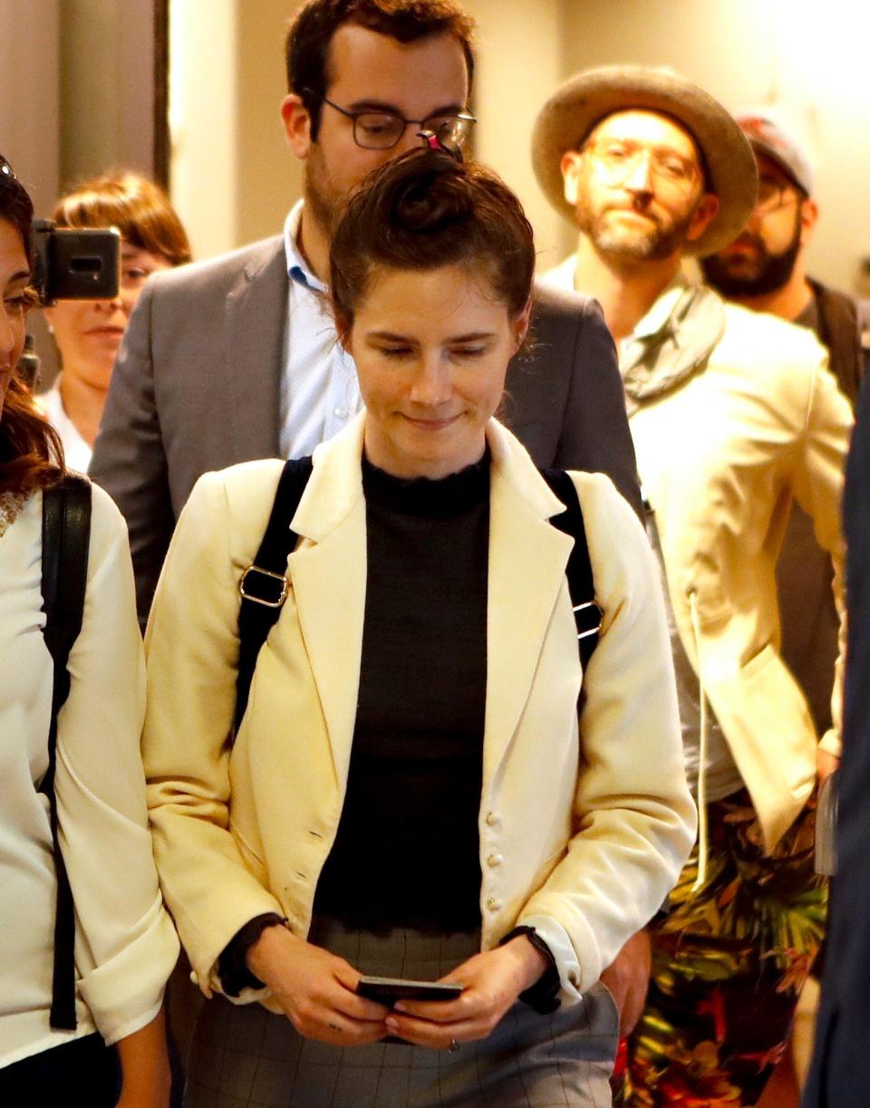 Amanda Knox exits the airport from a side entrance upon her arrival in Linate airport, Milan, Italy, Thursday, June 13, 2019. Knox has returned to Italy for the first time since she was convicted and imprisoned, but ultimately acquitted, for the murder and sexual assault of her British roommate Meredith Kercher in 2007.