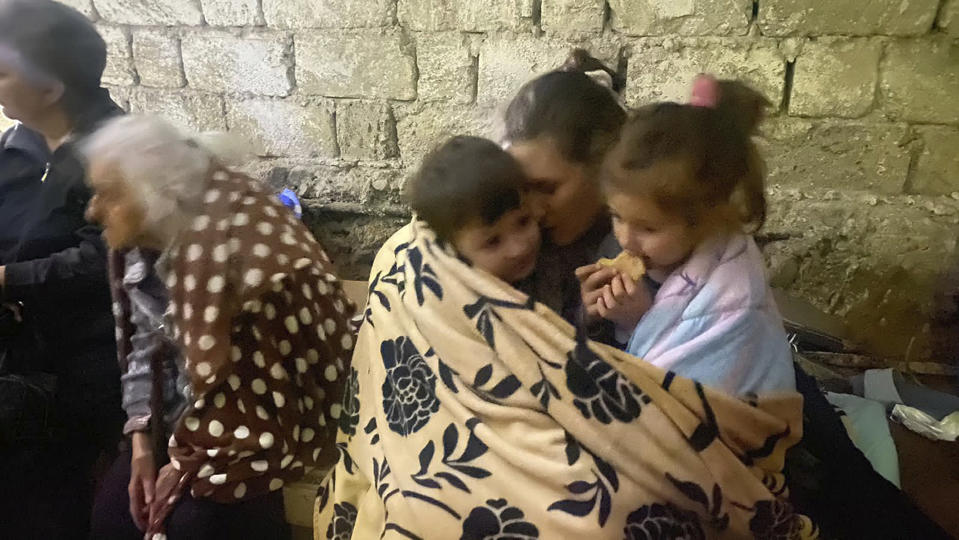 Children eat sitting in a shelter during shelling in Stepanakert in Nagorno-Karabakh. Azerbaijan on Tuesday declared that it started what it called an "anti-terrorist operation" targeting Armenian military positions in the Nagorno-Karabakh region and officials in that region said there was heavy artillery firing around its capital. (AP Photo/Siranush Sargsyan)