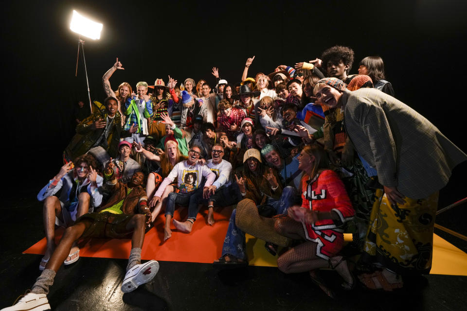 Designers Dan Caten, centre left, and Dean Caten, centre right, pose with models backstage after the at Dsquared2 men's Spring Summer 2023 collection presented in Milan, Italy, Friday, June 17, 2022. (AP Photo/Luca Bruno)