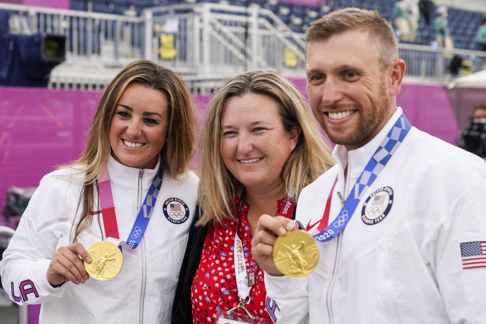 Amber English, left, and Vincent Hancock, right, both of the United States, celebrate taking the gold medal in the women's and men's skeet with Olympic medalist Kim Rhode at the Asaka Shooting Range in the 2020 Summer Olympics, Monday, July 26, 2021, in Tokyo, Japan. (AP Photo/Alex Brandon)