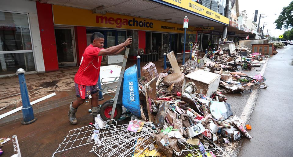 Local Lismore resident Jo Beardo helps with the clean up in Lismore's CBD on Thursday after severe flooding