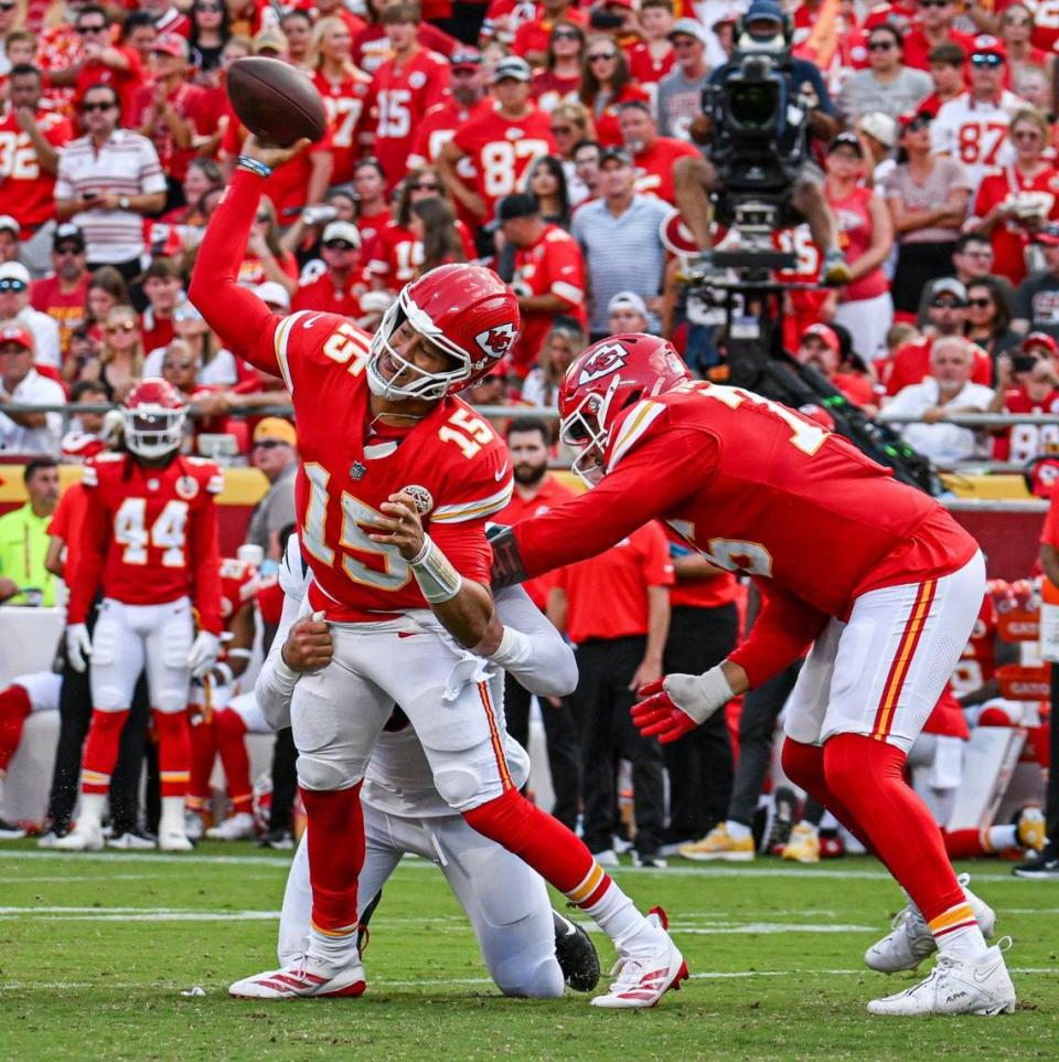 Kansas City Chiefs quarterback Patrick Mahomes (15) is sacked by Cincinnati Bengals defensive end Trey Hendrickson (91) while Chiefs lineman Kingsley Suamataia attempts to fend off Hendrickson in the fourth quarter Sunday, Sept. 15, 2024, at GEHA Field at Arrowhead Stadium.