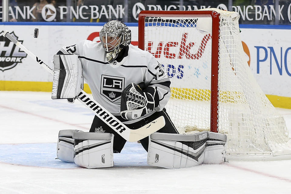 Los Angeles Kings' goaltender Jonathan Quick (32) deflects the puck during the second period of an NHL hockey game against the St. Louis Blues, Monday Feb. 22, 2021, in St. Louis. (AP Photo/Scott Kane)