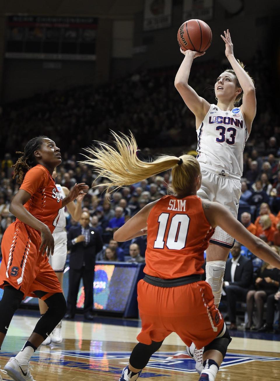 Connecticut's Katie Lou Samuelson, shoots over Syracuse's Gabby Cooper, left, and Isabella Slim, center, during the first half of a second-round game in the NCAA women's college basketball tournament, Monday, March 20, 2017, in Storrs, Conn. (AP Photo/Jessica Hill)