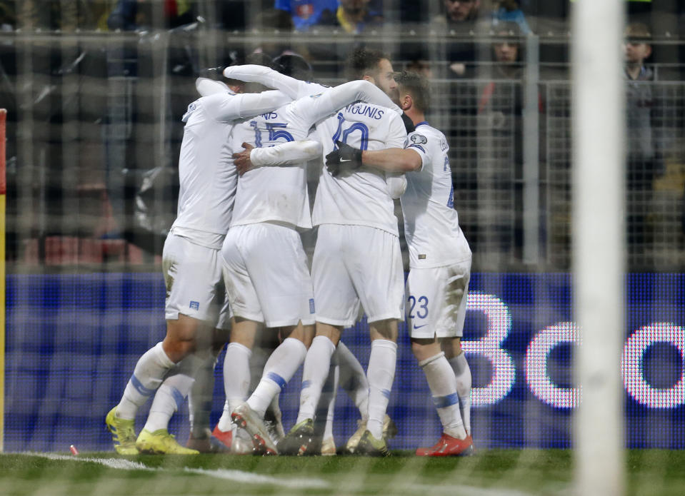 Greek players celebrate their team's second goal during the Euro 2020 group J qualifying soccer match between Bosnia-Herzegovina and Greece in Zenica, Bosnia, Tuesday, March 26, 2019. (AP Photo/Darko Bandic)