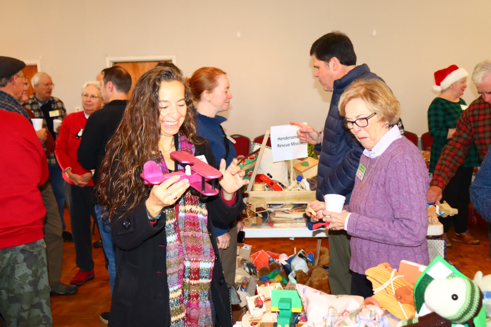 Linda Block from Children & Family Resource Center, left, and Hendersonville Mayor Barbara Volk look at the toys being donated by Apple Country Woodcrafters on Dec. 5 at the Hendersonville Elks Club.