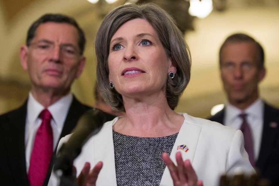 Sen. Joni Ernst, R-Iowa, speaks during a media availability after their policy luncheon on Capitol Hill, Tuesday, May 7, 2019 in Washington. Ernst is accompanied by Sen. John Barrasso, R-Wyo., left, and Sen. John Thune, R-S.D. (AP Photo/Alex Brandon)