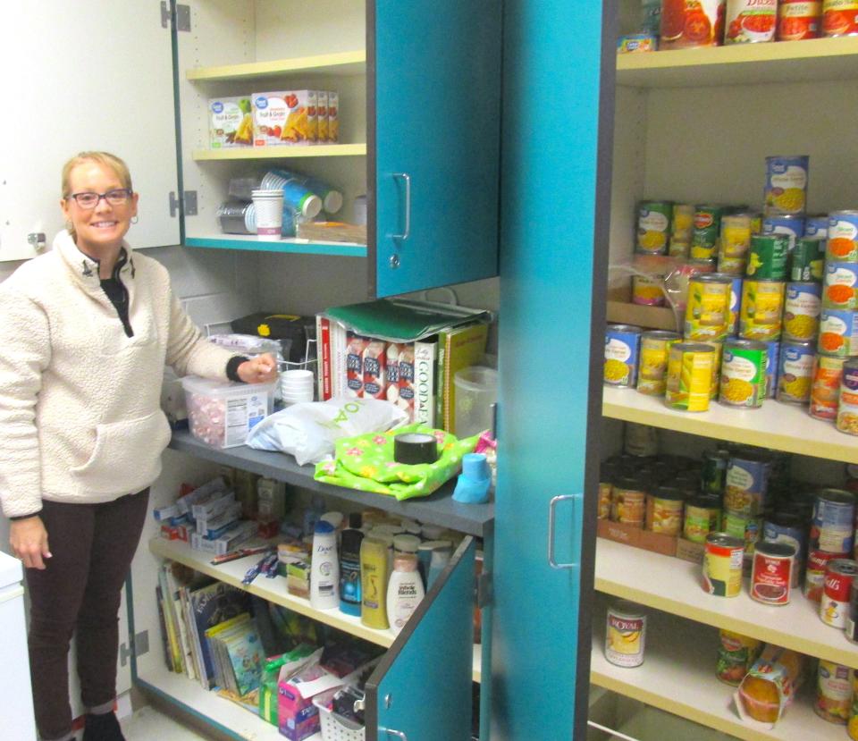 Tess Kinsey displays the food and  personal products available to students in the comfort closet in her classroom.