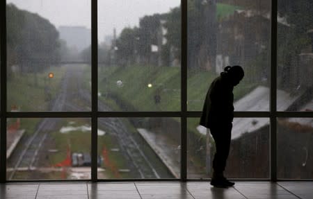 A man stands at the Aristobulo del Valle train station during a national blackout, in Buenos Aires